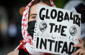 A student protester holds a sign reading "Globalize the Intifada" at Columbia University in New York City - source: Reuters