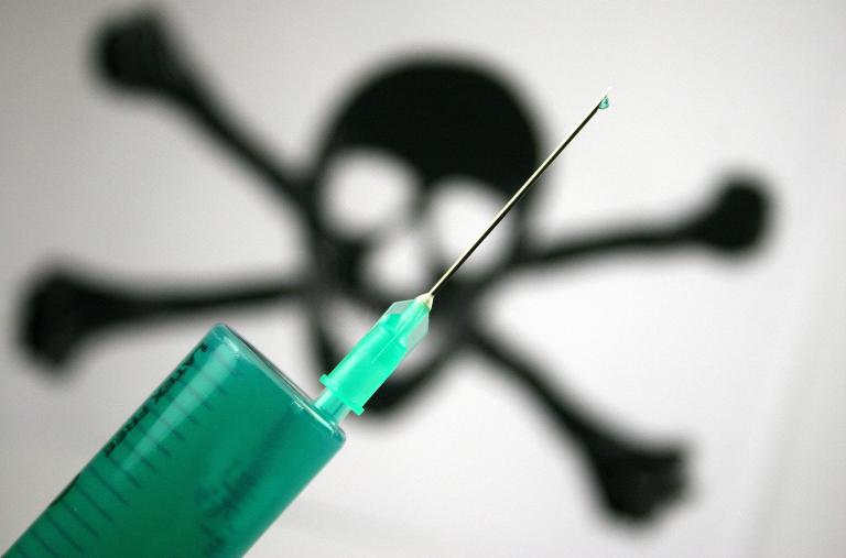 A photo illustration of a hypodermic needle and a poison symbol - source: Reuters