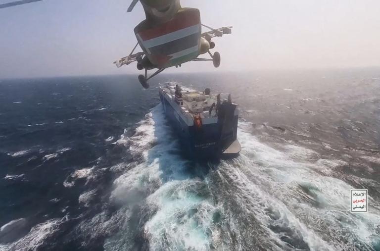 A Houthi helicopter approaches a civilian cargo ship in the Red Sea in 2023 - source: Reuters