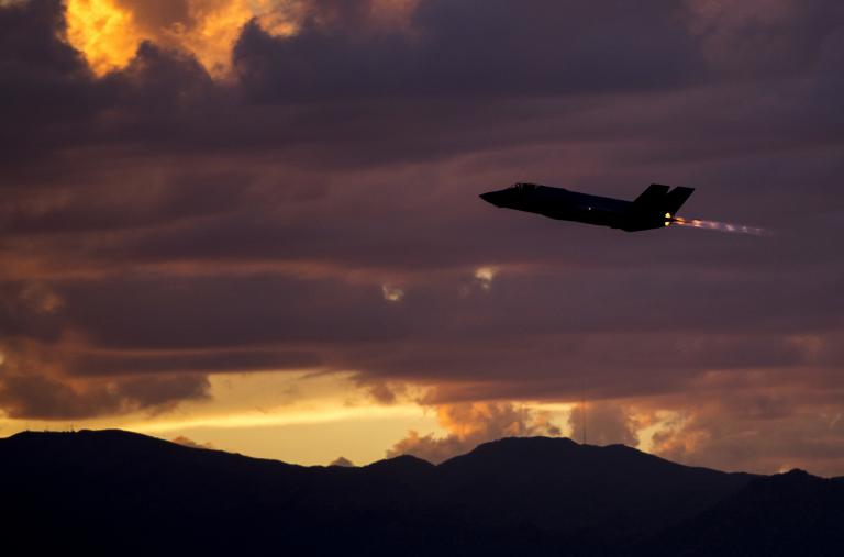 An F35A fighter on a night-training mission at dusk