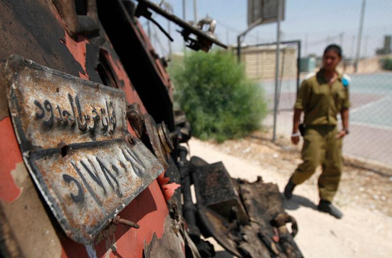 An Egyptian guard inspects bomb damage near the Gaza border in Sinai