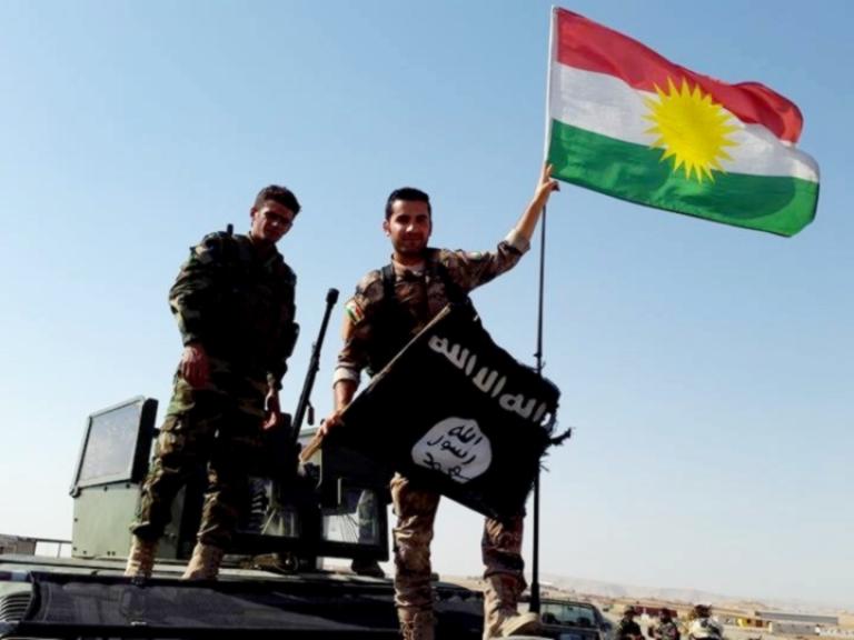 Peshmerga fighters throwing away ISIS flag