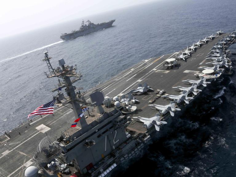 The US Navy carrier Abraham Lincoln sails alongside an escort destroyer - source: U.S. Navy