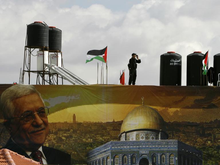 A police officer loyal to the Palestinian Authority stands guard on a wall at PA headquarters in Ramallah in 2007 - source: Reuters