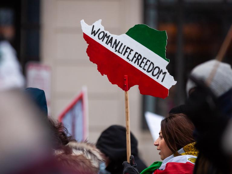 Iranian-American demonstrators hold signs at a protest in Washington, DC - source: Reuters