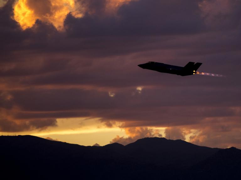 An F35A fighter on a night-training mission at dusk