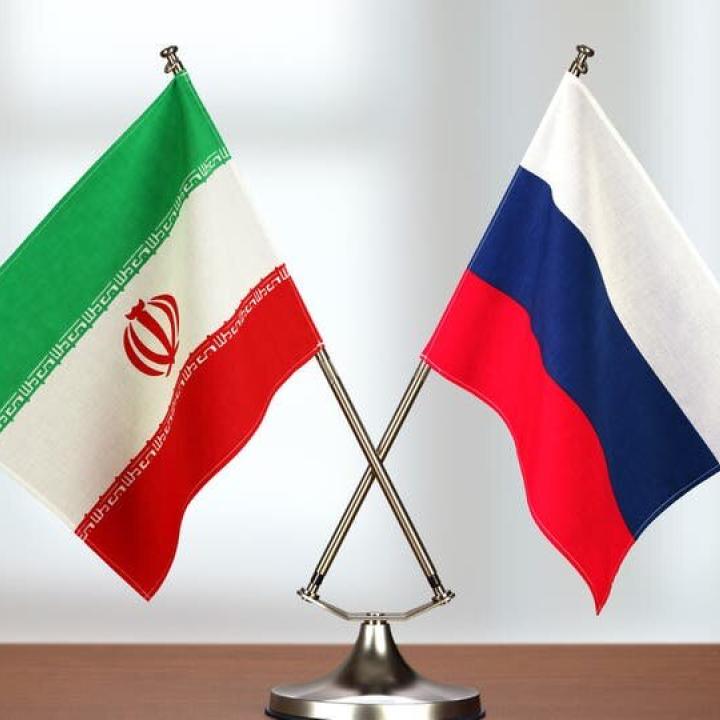 Iranian and Russian flags on a table