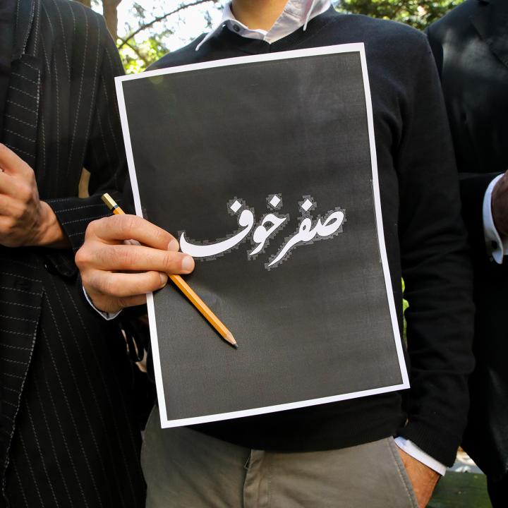 Lebanese protesters hold signs reading "Fearless" in Arabic in response to the assassination of Lokman Slim - source: Reuters