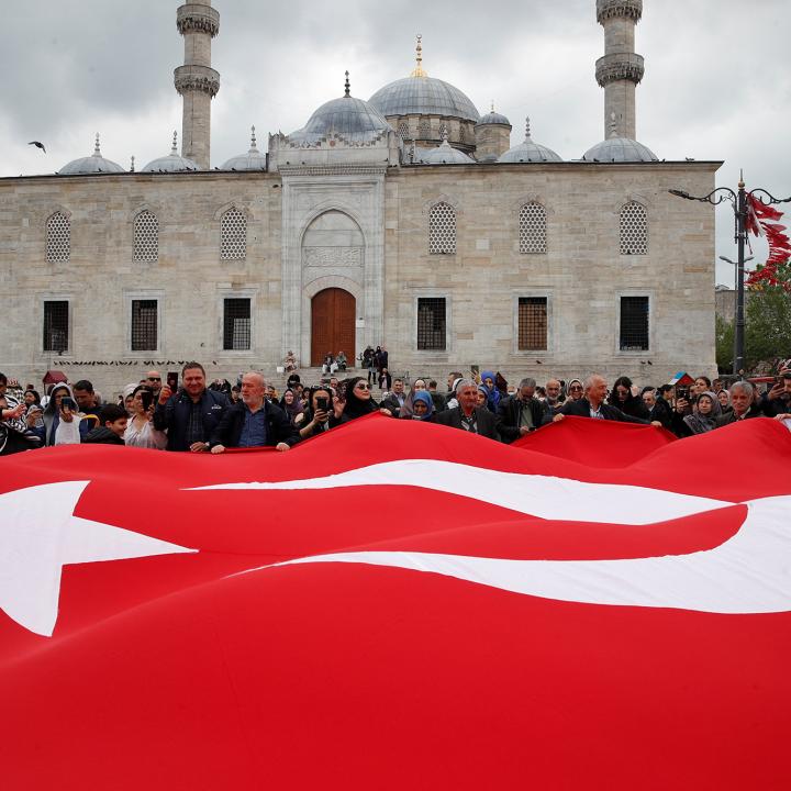 Supporters of Turkish president Erdogan display a large flag - source: Reuters