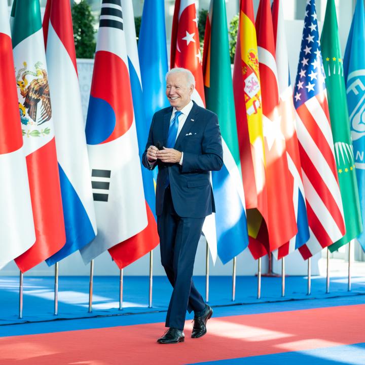 President Joe Biden walks past flags of the member states at a G20 meeting - source: The White House