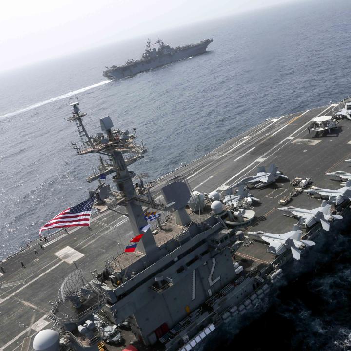 The US Navy carrier Abraham Lincoln sails alongside an escort destroyer - source: U.S. Navy