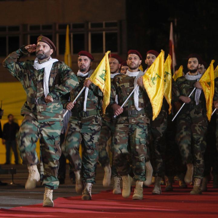 Hezbollah fighters parade with flags in Lebanon in 2019 - source: Reuters