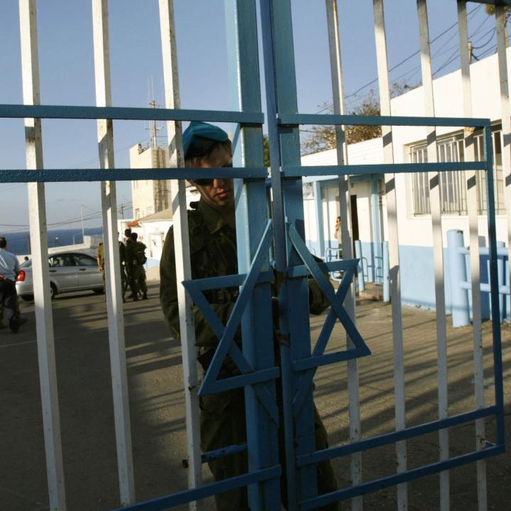 An Israeli border guard secures the gate at a crossing with Lebanon in 2007 - source: Reuters