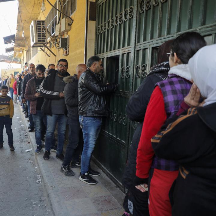 People queue for bread in rebel-occupied Aleppo in December 2024 - source: Reuters