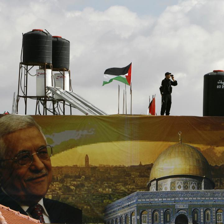 A police officer loyal to the Palestinian Authority stands guard on a wall at PA headquarters in Ramallah in 2007 - source: Reuters