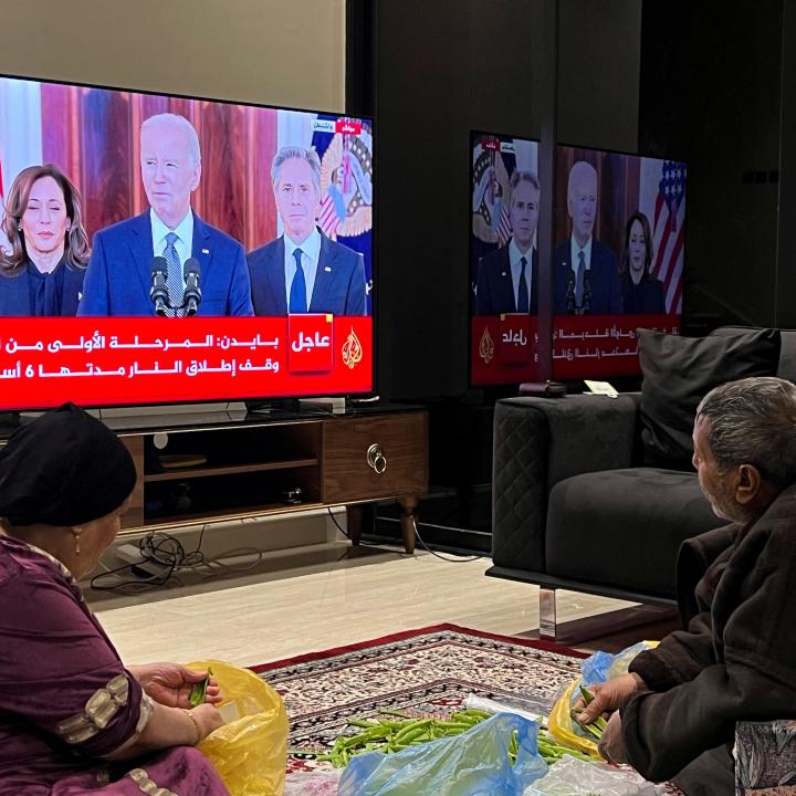 A photo of Palestinians watching President Biden's announcement of the Gaza ceasefire deal, January 2025.