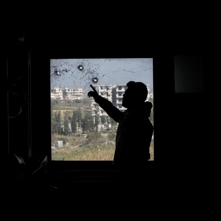 A Syrian man points at bullet holes in a window of a hospital in Jableh town, 25 km south of Latakia, following a spate of violence between Syrian security forces and insurgents loyal to deposed president Bashar al-Assad - source: Reuters