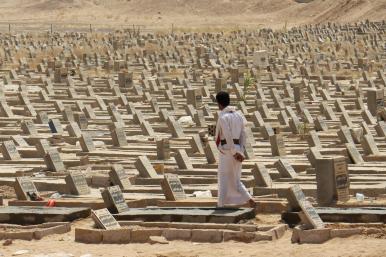 A man walks in a graveyard in Marib, Yemen