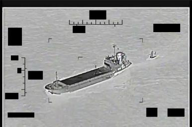 U.S. Navy image of an Iranian vessel attempting to capture a U.S. naval drone - source: Department of Defense