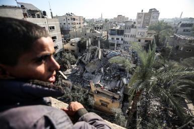 A Palestinian views a building reduced to rubble in Gaza - source: Reuters