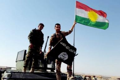 Peshmerga fighters throwing away ISIS flag