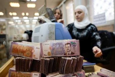 Workers package Syrian pound currency notes at the Syrian Central Bank in Damascus following the fall of the Assad regime in December 2024 - source: Reuters