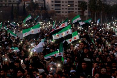 Syrian civilians celebrate the fall of the Assad regime in downtown Damascus in December 2024 - source: Reuters