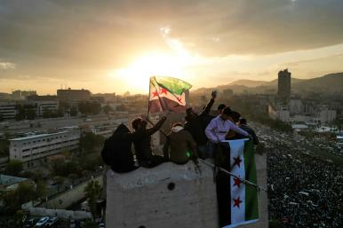 Syrian civilians celebrate the fall of the Assad regime in December 2024 in downtown Damascus - source: Reuters