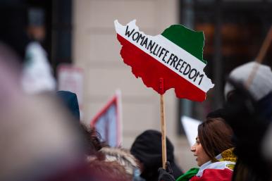 Iranian-American demonstrators hold signs at a protest in Washington, DC - source: Reuters