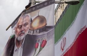A poster depicts former Hamas leader Ismail Haniyeh alongside the Iranian flag in Tehran following Haniyeh's killing in Iran - source: Reuters