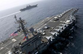 The US Navy carrier Abraham Lincoln sails alongside an escort destroyer - source: U.S. Navy